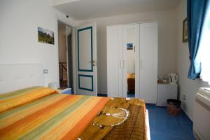 a bedroom with a bed and a blue floor at Il Sestante B&B in Condofuri