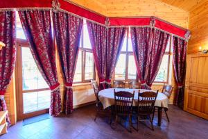 a dining room with a table and some windows at Petrovskyi Brovar in Brovary