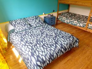 a bedroom with a bed and a dresser with a bed sqor at LES MIGLOU - Maison picarde entre Paris et la Champagne ! in Nogentel +8 photos