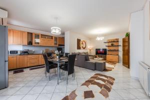 a kitchen and living room with a couch and a table at Premium Sea View Big Apartament in Durrës