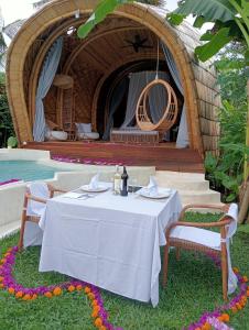 a table and chairs in front of a yurt at Gladak di Uma Bali in Sidemen