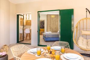 a dining room with a table and chairs and a bedroom at Koukos Loft Apartments in Tsilivi