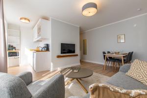 a living room with a couch and a table at Parkside Central Apartment by Kuus Sõlme in Kuressaare