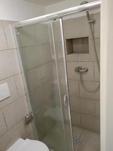 a bathroom with a glass shower with a toilet at Laura in Gallipoli +11 photos