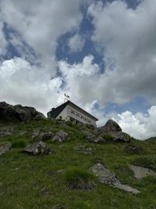 a building on top of a hill with rocks at Gogi Ski Resort in Gudauri