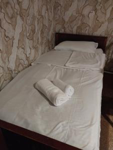 a bed with two rolled up towels on it at GALA Guesthouse in Alaverdi