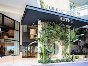 a store front of a store with plants on it at Croisette Beach Hotel Cannes - MGallery Collection in Cannes
