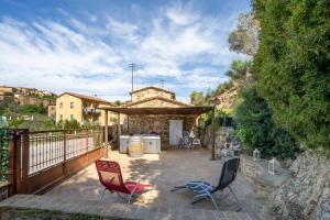 a patio with two chairs and a building at casa vacanza sant' antimo in Montalcino