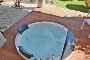 a circular pool on a wooden deck with at Corte Bianca - Adults Only & SPA - Bovis Hotels in Cardedu