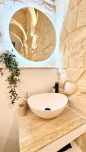 a bathroom with a sink and a stone wall at MCC St Rita in Il-Furjana