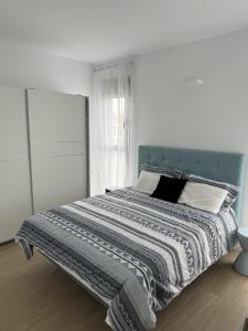 a bedroom with a large bed with a blue headboard at Luxury Villa Torrevieja With Swimmingpool in Torrevieja