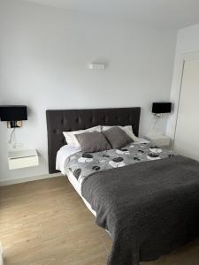 a bedroom with a large bed and two lamps at Luxury Villa Torrevieja With Swimmingpool in Torrevieja +14 photos
