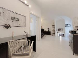 a white room with a kitchen with a chair in it at Via Pia Elegante Suite Di Design Crociere 2' in Savona +25 photos
