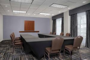a conference room with a long table and chairs at Homewood Suites by Hilton Omaha - Downtown in Omaha