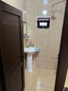 a bathroom with a sink and a shower at Holiday home in Kiş +34 photos