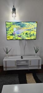 a living room with a tv on a wall at Ideal Haven Westlands in Nairobi
