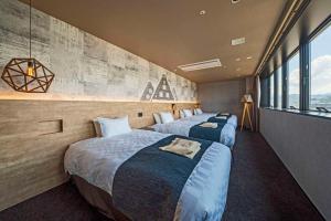 Voodi või voodid majutusasutuse hotel around TAKAYAMA, Ascend Hotel Collection toas