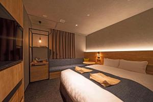 Voodi või voodid majutusasutuse hotel around TAKAYAMA, Ascend Hotel Collection toas