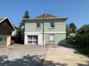 a large house with a driveway in front of it at Studio TOURNETTE in Chambéry
