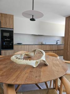 a wooden table with a skull on top of it at Limens Luxury Apartment in Cangas de Morrazo