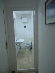 a bathroom with a toilet and a sink at brisa mar in San Pol de Mar +8 photos