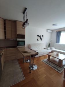 a living room with a table and a couch at Merkur Lux in Budva