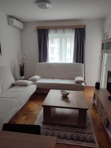 a living room with a couch and a coffee table at Merkur Lux in Budva