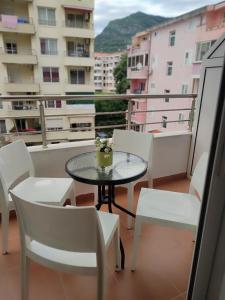 a table and chairs on a balcony with a view at Merkur Lux in Budva
