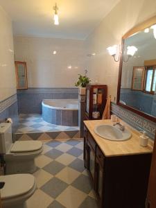 a bathroom with a tub and a sink and a toilet at Aires Del Ambroz in Casas del Monte +38 photos