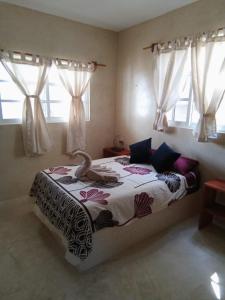 Ένα ή περισσότερα κρεβάτια σε δωμάτιο στο Villa Yum Balam en Holbox