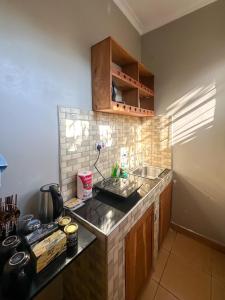 a kitchen with a sink and a counter top at Actionpack Travels in Dar es Salaam
