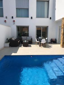 a swimming pool in front of a house at Luxury Villa Torrevieja With Swimmingpool in Torrevieja