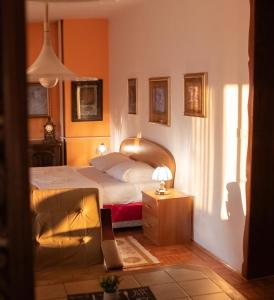 a bedroom with a bed and a table with a lamp at Hondo Rooms & Apartments in Sarajevo