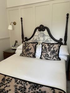 a bed with black and white pillows on it at AmarAgua Guest house in Edinburgh