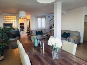 a living room with a table with flowers on it at La Casa Amarilla in San Miguel de Abona