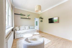 a living room with a couch and a table at Nad Brzegiem in Mrągowo