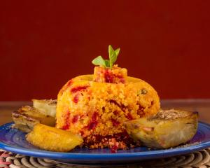 a blue plate with a piece of food on a table at Mais Que Nada Itacaré - Hostel, Bar & Breakfast in Itacaré +106 photos