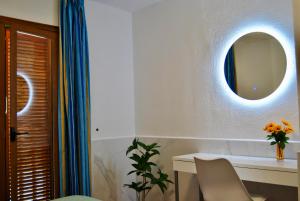 a room with a table and a mirror on the wall at Montecarlo 35 or 45 first row with air conditioning & WI-FI & sound insulation in Puerto Rico de Gran Canaria