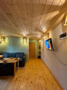 a living room with a blue couch and a table at Big stone in Dilijan +22 photos