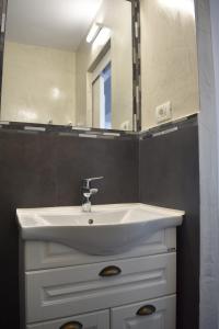 a bathroom with a white sink and a mirror at Central Mangalia in Mangalia