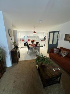 a living room with a couch and a table at The Bear Apartments in Llandovery