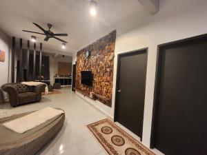 a living room with a ceiling fan and a fireplace at The Bunker StudioStay in Arau