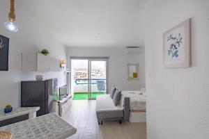 a living room with a bed and a couch in a room at PANORAMIC VIEW Playa Paraíso in Adeje