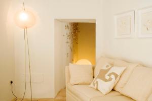 a living room with a white couch and a lamp at S'Hotelet de Santanyi in Santanyi
