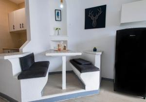 a small kitchen with a table and a stool at PANORAMIC VIEW Playa Paraíso in Adeje