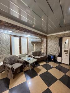 a living room with a checkered floor at Hotels Piza in Tbilisi City