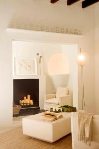 a living room with a couch and a fireplace at S'Hotelet de Santanyi in Santanyi