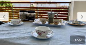 a table with two cups and saucers on it at Casa Omero in Sperlonga