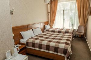 阿拉木圖的住宿－阿約爾酒店，酒店客房设有两张床和窗户。