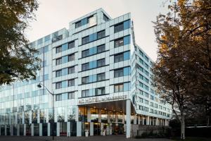 an office building with a glass facade at AC Hotel Paris Porte Maillot by Marriott in Paris